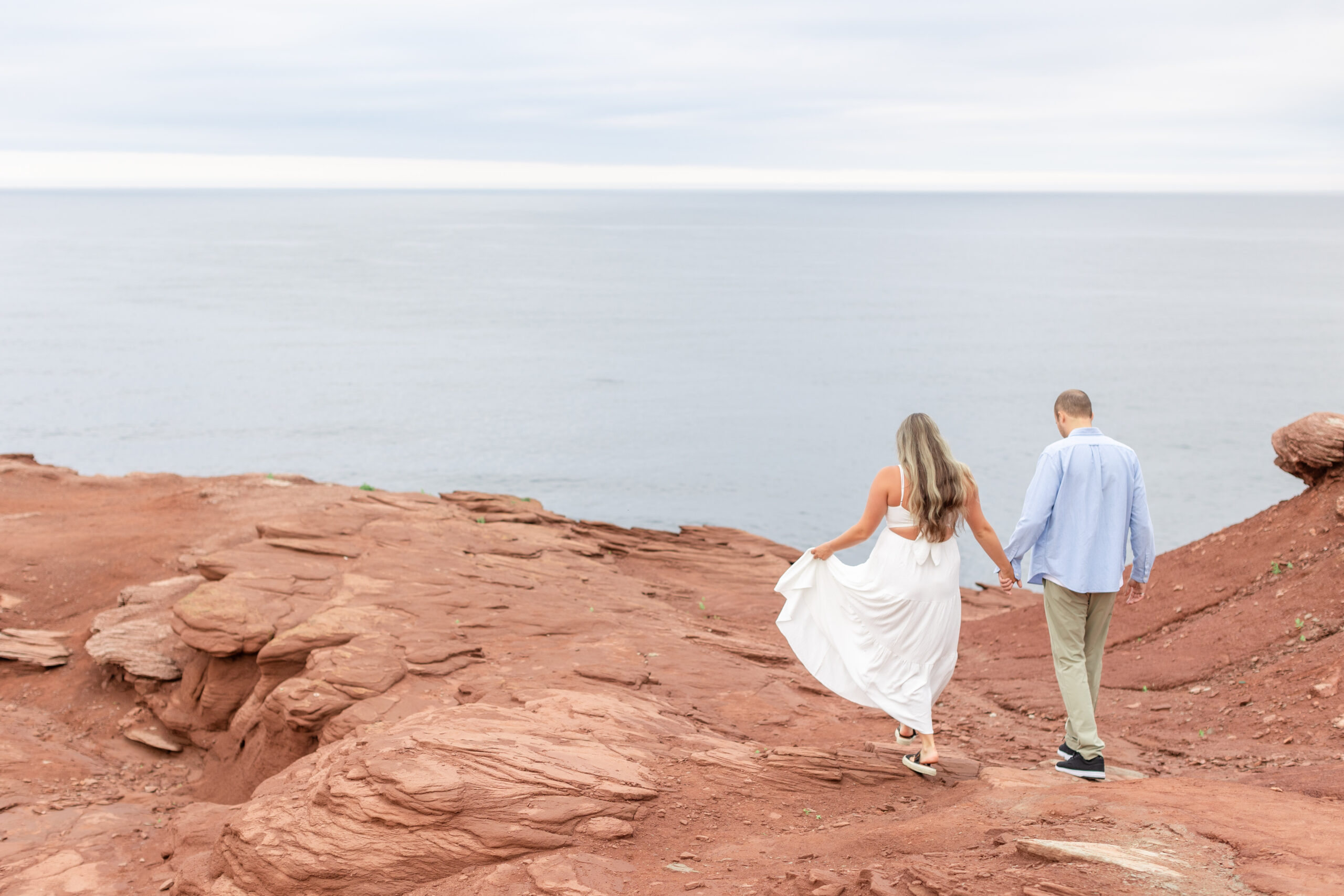 Couple walking on cliffs at Cape Tryon Lighthouse